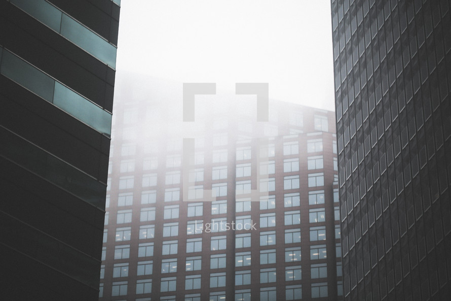 windows on a building in a foggy city 