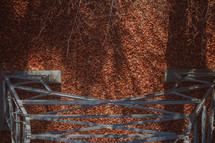 Metal tower structure looking down on fall leaves