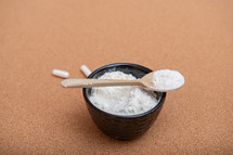 Collagen powder on a wooden spoon with copy space