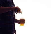 a man pouring a beer 
