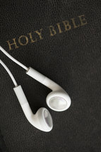 Ear buds on a Bible.