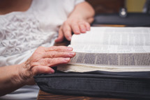 elderly woman reading a Bible 