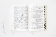 Ear phones on an open Bible.