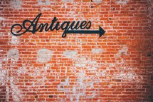 Antiques sign on a brick wall 