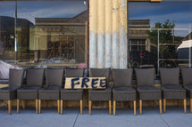 a row of chairs for free outside a demolished building