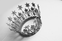 A crown rests on a white backdrop.