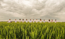 family standing in a wheat field 