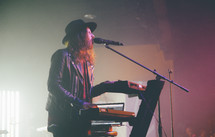 man playing a keyboard on stage 