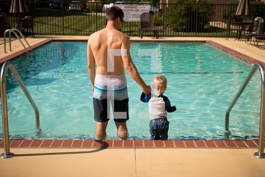 father and son at a public pool 