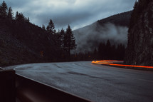 taillights blurring has they travel on a curvy mountain road 