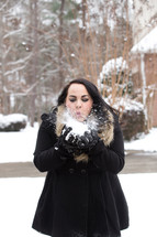 a woman holding a snowball 