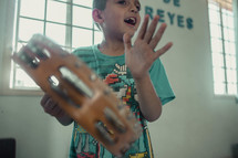 a child playing tambourines 