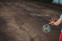 child playing with a bubble 