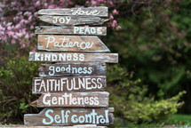 The fruit of the Spirit written on a sign made of rustic wooden planks.