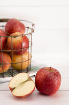 wire basket with apples 