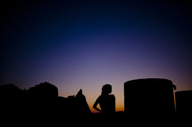 Silhouette of a woman at dusk.