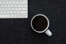 computer keyboard and coffee mug 