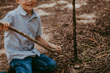 a boy playing with sticks 