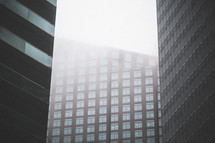 windows of a city building and fog