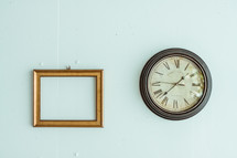 empty frame and clock on a wall 