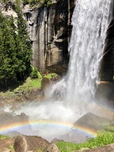 rainbow at the bottom of a waterfall 