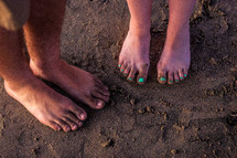 couples bare feet in the sand 