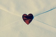 red heart sticker on a white envelope 