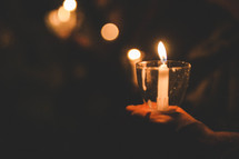 holding a candle at a candlelight service 