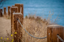 chains on a fence along a shore 