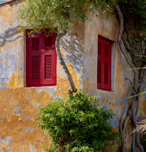 red shutters on a windows 