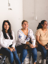 group of women sitting and smiling 