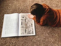 a child reading a Biblical comic strip 