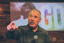 a man at a microphone giving a speech 
