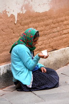 Homeless woman begging on the street