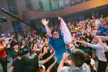 standing with hands raised at a worship service 