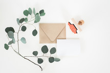 envelope, letter, paper, stamp, and stick with green leaves
