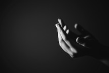 Hands outstretched in prayer