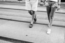 a couple in shorts walking holding hands 