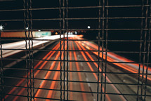 view of taillights in motion on a freeway at night 