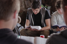 young men at a Bible study reading Bibles 
