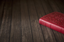 red Bible on wood 