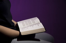 a woman reading a Bible in her lap 