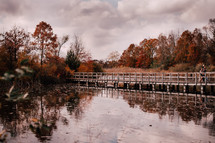 Fall colors with wooden bridge over water