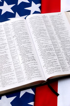 open Bible on an American flag 