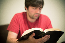 man reading a Bible 