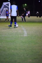 a young man standing on a soccer field 