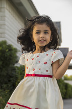 a toddler girl in a floral formal dress 