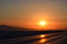 orange sky at sunrise over a freeway in Nevada 