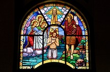Stained glass window of the Baptism of Jesus by John the Baptist