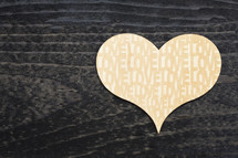 word love on a wooden heart cut out 